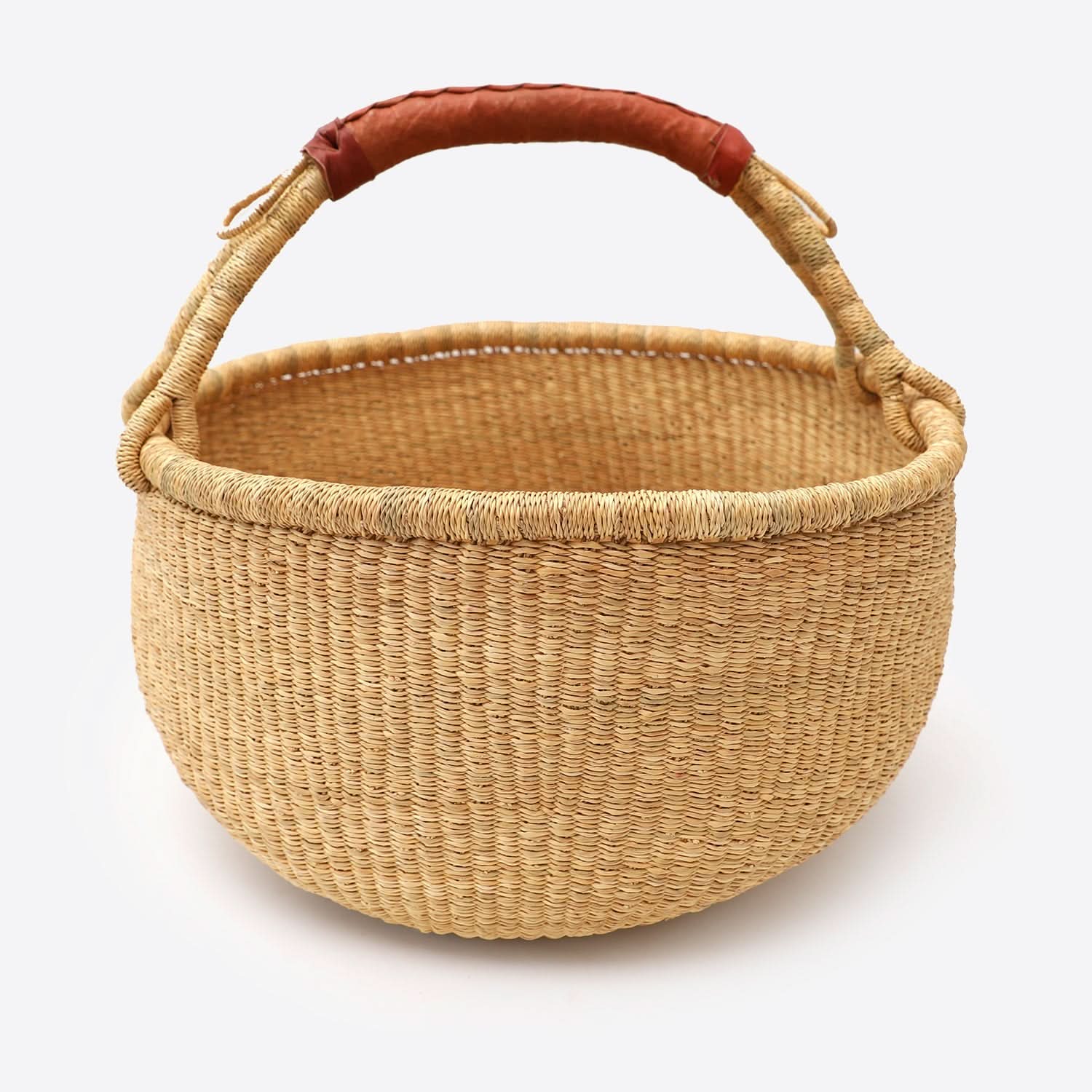 Natural raffia wool woven storage basket dirty laundry with leather handle on white background.